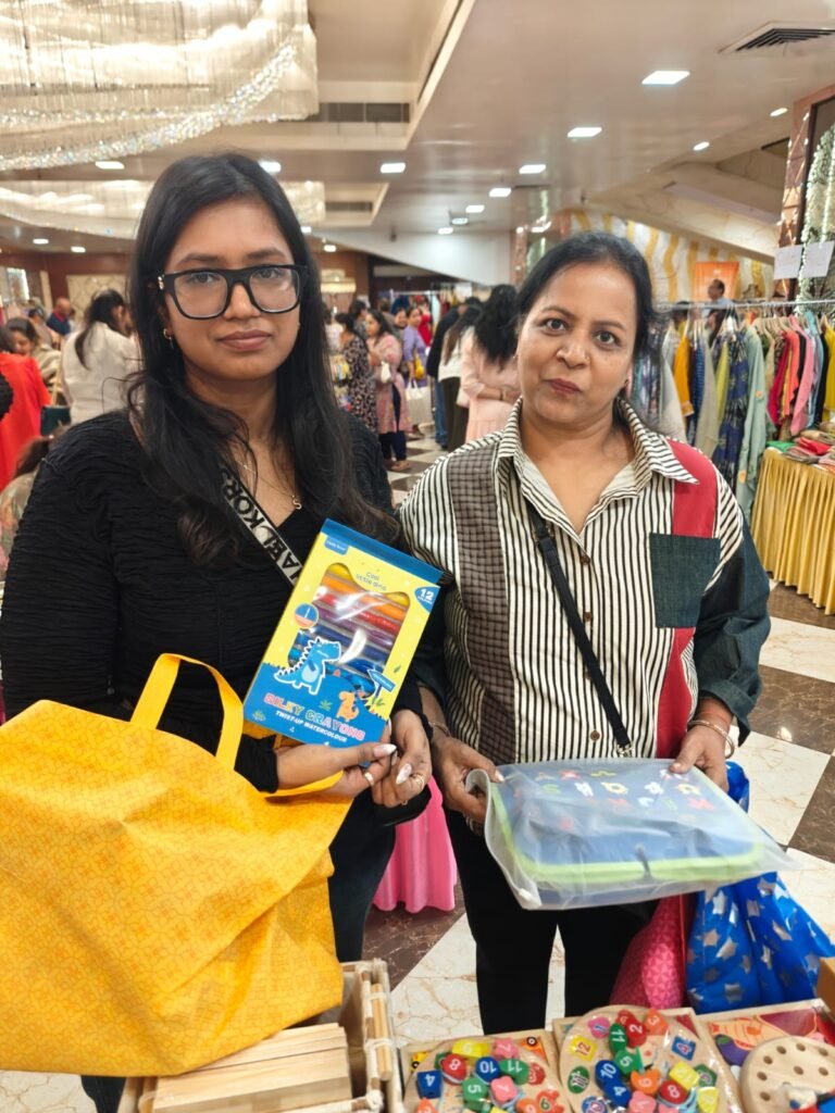 Two customers showing the picture book and craft kit they bought from Parent Oven