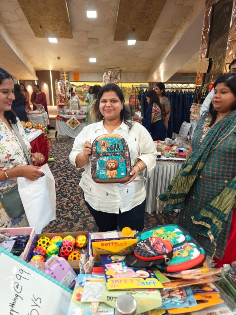 A happy customer holding a kids’ backpack bought at the Parent Oven stall