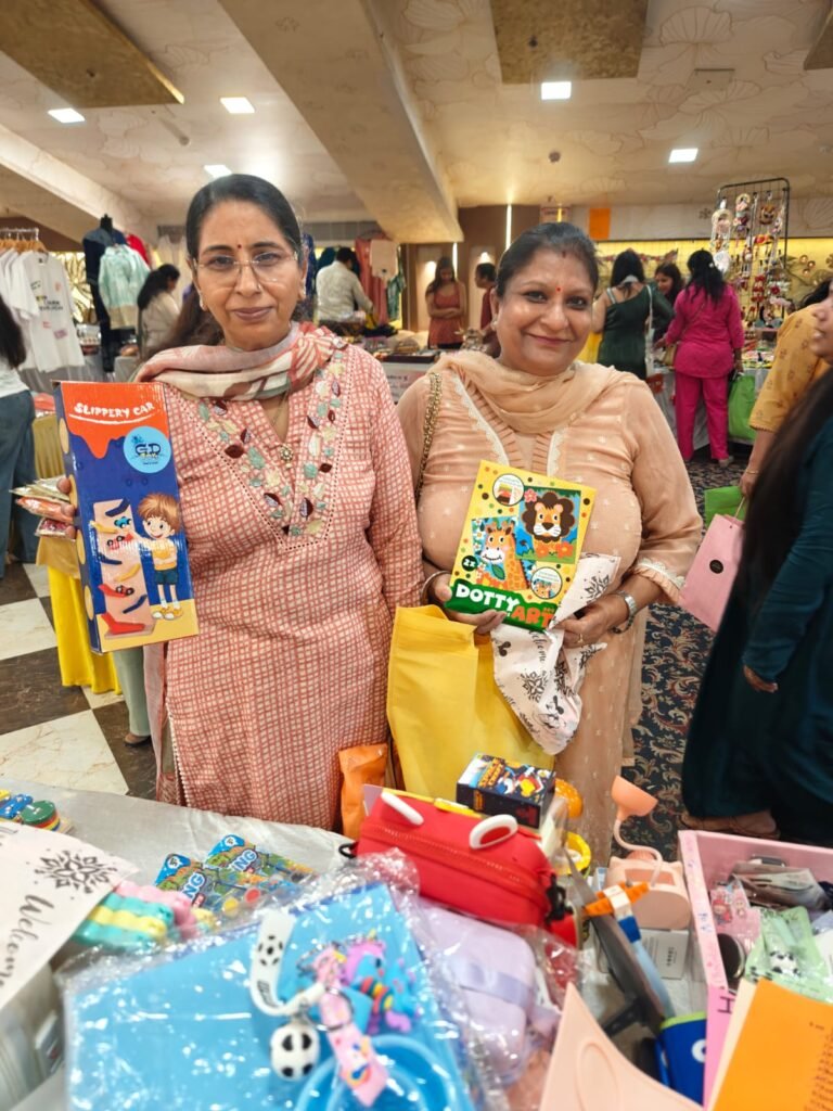 Two smiling customers holding books and toys from Parent Oven