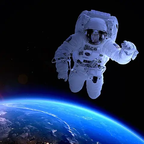 An astronaut in a white spacesuit floating above the Earth