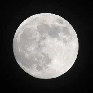 A bright full Moon in a dark sky