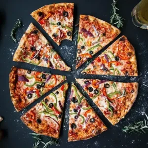 A whole round pizza cut into slices