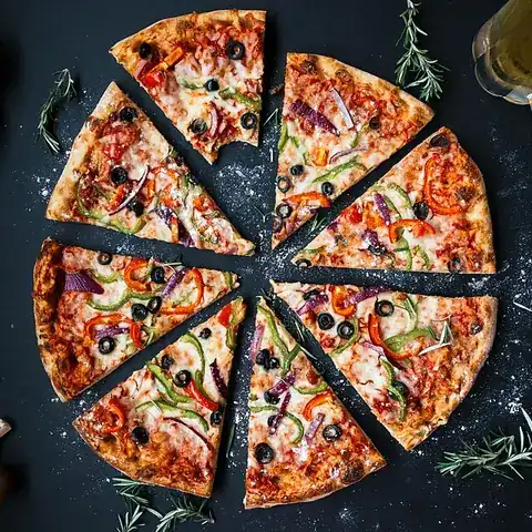 A whole round pizza cut into slices